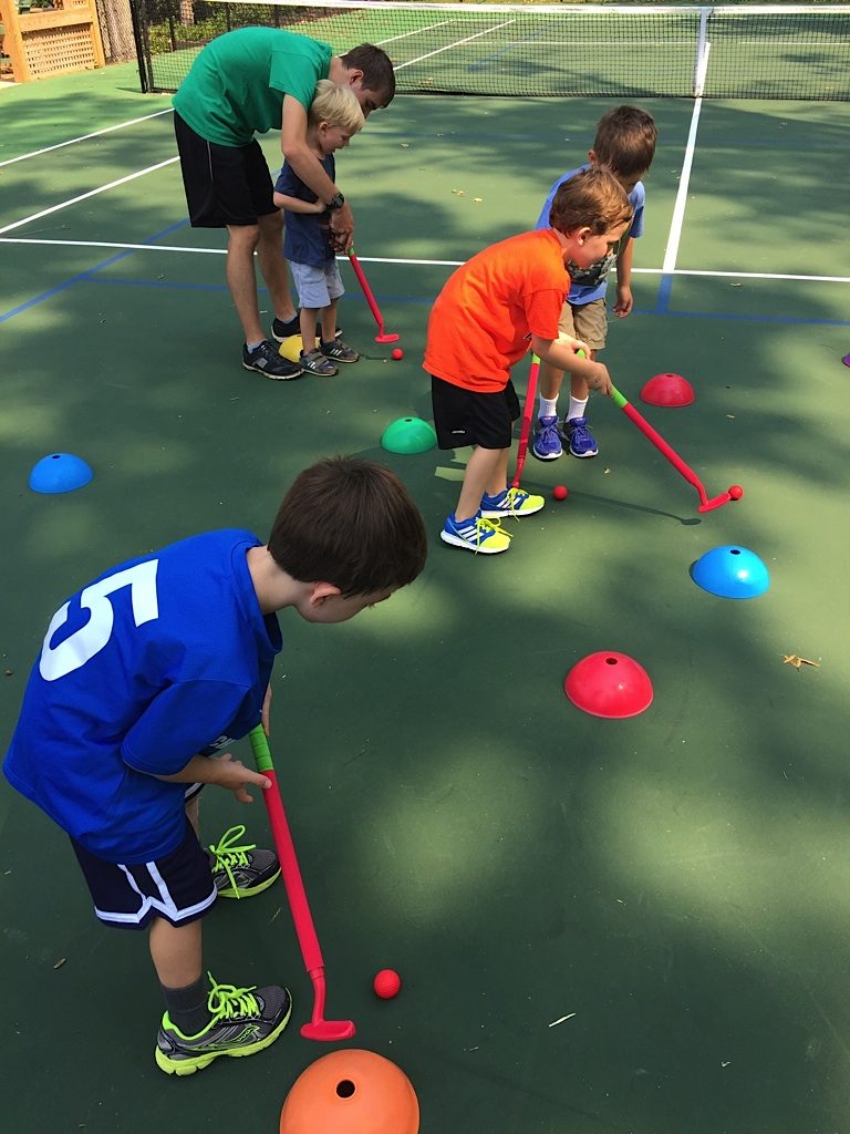 Little Kids playing Golf